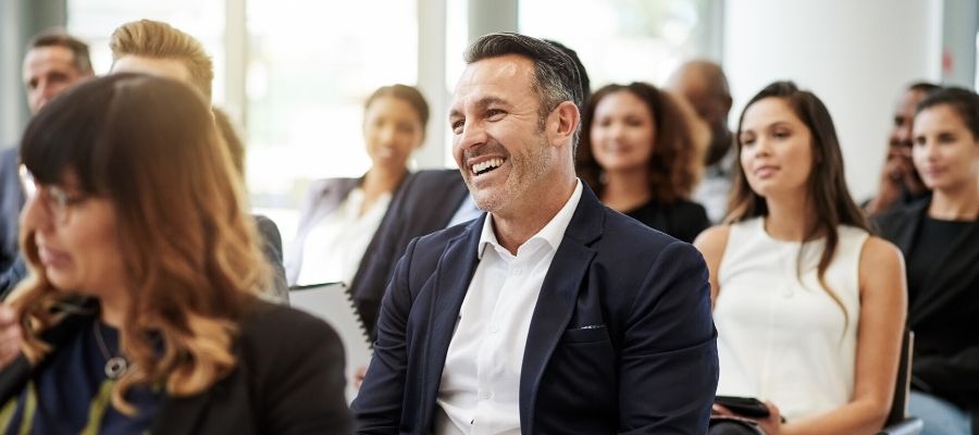 man smiling in seminar