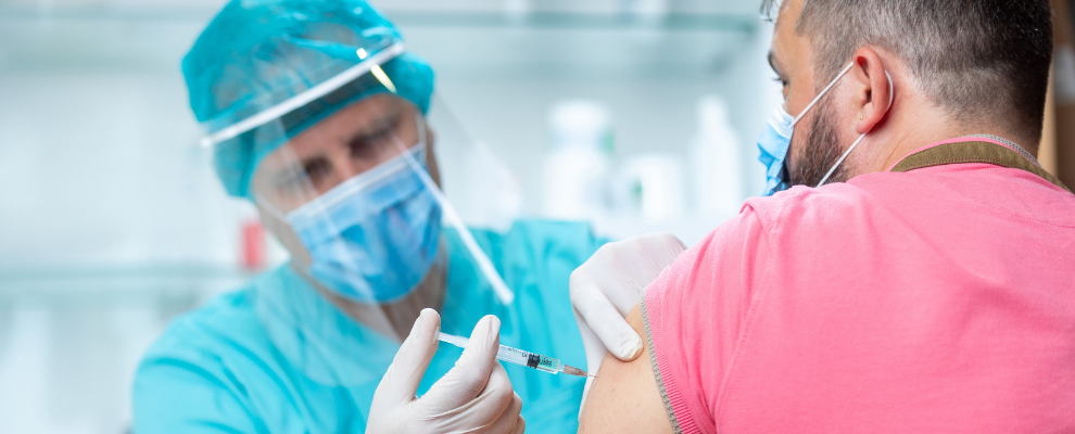 man administering vaccine